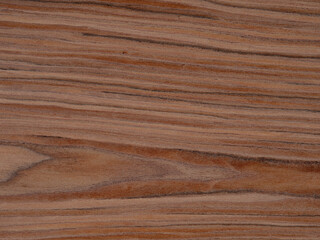 Warm sepia and russet stripes traverse the polished surface of this teak wood veneer