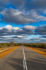 the asphalted road in the outback on an overcast day