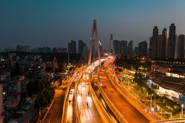 Obraz premium Night view aerial shot of a group of tall buildings along the Han River in Wuhan.