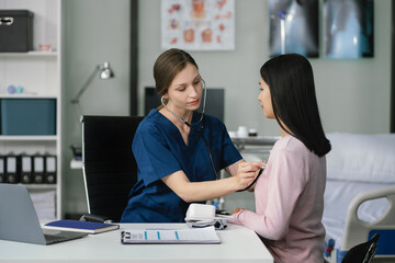 Doctor with stethoscope examining patient with examination, presenting symptoms and recommending...