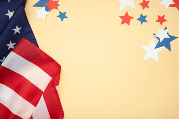 White, blue and red decorations to celebrate July 4th. American flag with paper star on beige...