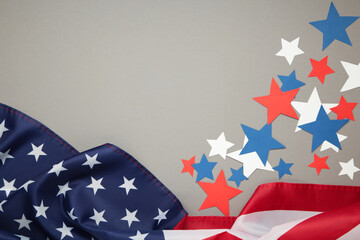 White, blue and red decorations to celebrate July 4th. American flag with paper star on grey background.