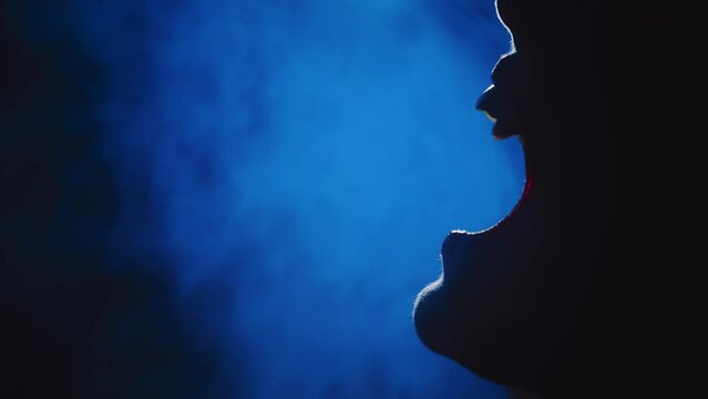 art portrait mouth close-up fantasy vampire person screams growls hisses shows sharp white teeth fangs lips beauty part face gothic woman in moon light night smoke fog. dark room sexy girl werewolf 4k