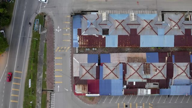 Moving to the right, an aerial top-down view of the old, rusty roof at the Malaysian rest and relax hawkers stall in Port Dickson. 4K