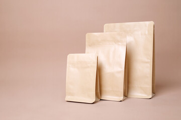 Arrangement Of Three Standing Brown Coffee Packaging Over Brown Background