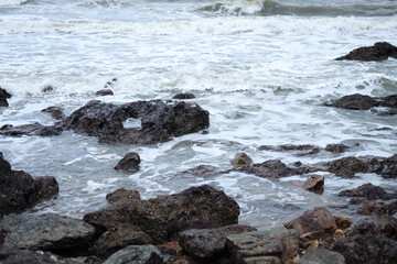 Beautiful landscape of Rocky coastline and blue sea with cloud storm on the sky in Thailand.Seascape concept 