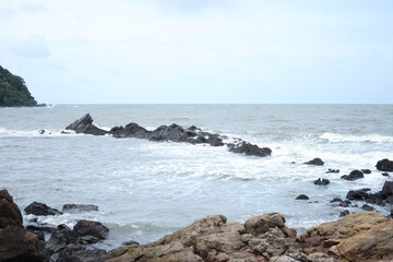 Beautiful landscape of Rocky coastline and blue sea with cloud storm on the sky in Thailand.Seascape concept 