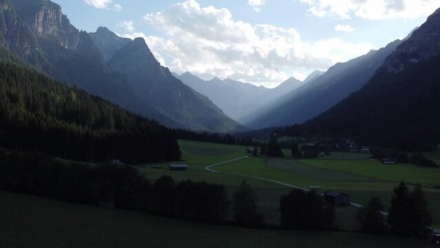 Mountains, meadows and woods in a mountainside village in Austria at the Brenner Pass at sunset