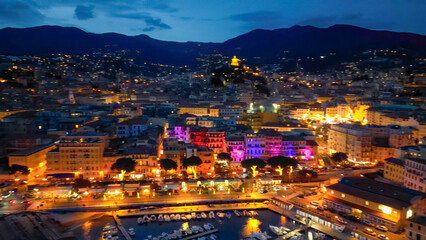 Aerial view of Sanremo at night, Italy. Port and city buildings