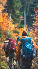 Fototapeta premium A group of diverse individuals, men and women of various ages, are hiking through a lush forest. They are wearing backpacks and sturdy hiking gear, navigating the rugged terrain as they explore nature