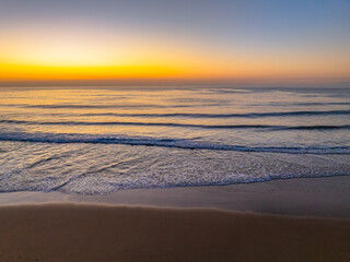Aerial sunrise at the beach with clear skies