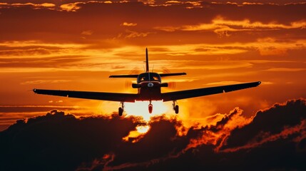 A motor plane silhouette flying against the backdrop of a colorful sunset sky. The vibrant hues of orange, pink, and purple enhance the scene as the aircraft soars through the clouds.