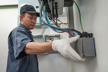 Professional solar engineer installing solar roof combiner box for home use
