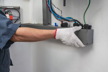 Close up solar technician install solar invertor combiner box