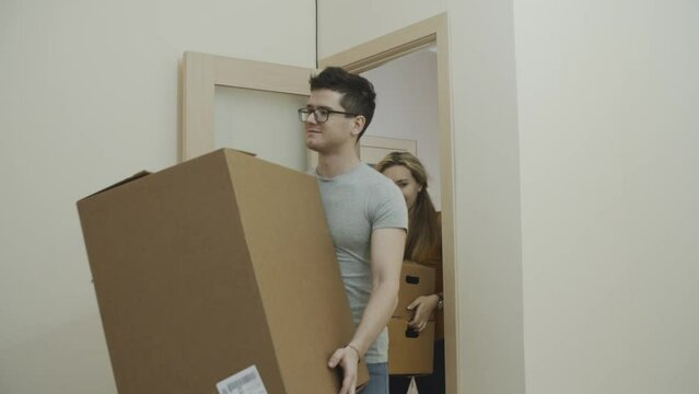 Young european couple moving into a new apartment . Charming lovers looking around the room and estimating the amount of future repair work. Concept of young family, new beginning and future.