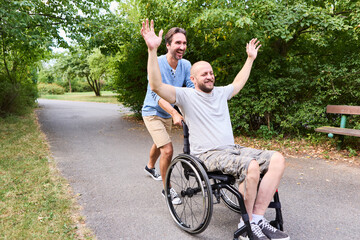 Man in wheelchair and friend enjoying a day at the park, sharing laughter and joy