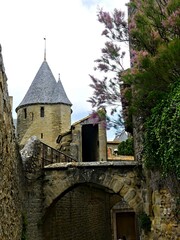 Fototapeta premium Carcassonne, May 2024: Visit the magnificent walled city of Carcassonne in Occitanie. Street photos - View of the fortified castle and ramparts protecting the historic town.