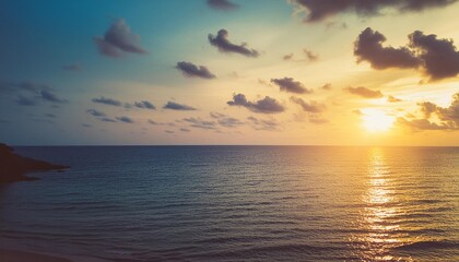 sea view at sunset summer travel background vintage filter beautiful blue sky with clouds and sun on the horizon of the sea