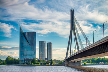 Fototapeta premium Riga, Latvia - July 7, 2017: Riga bridge and modern buildings on a sunny afternoon