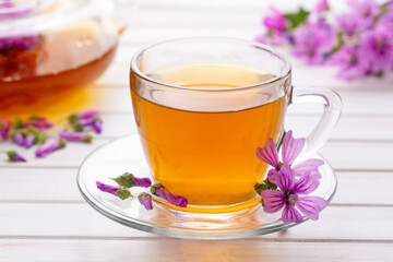 Mallow herb (Malva Vulgaris) mallow flower tea in cup.