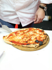 chef with artisanal pizza fresh from the oven