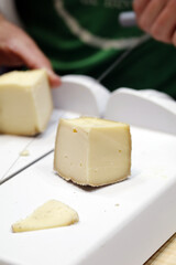 portion of freshly cut sheep's cheese with lira