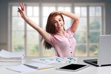 Joyful business woman worker freelancer sitting at desk