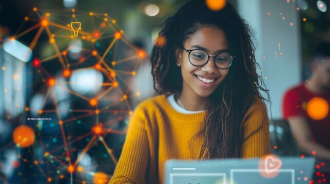 A young woman sitting in front of a laptop computer, working or studying intently.