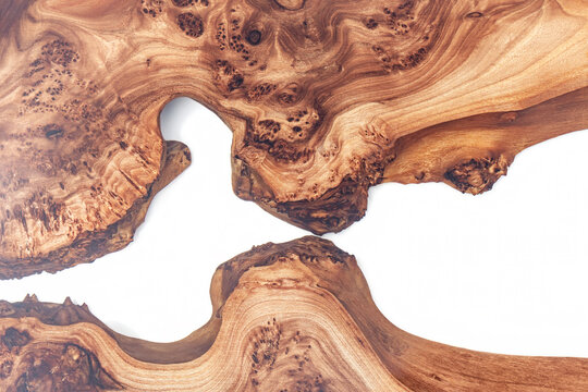 Live edge elm burl slab table top with central epoxy resin river on white background, combining natural wood with a synthetic material close view