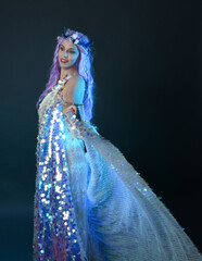 artistic portrait of beautiful female model with long purple hair wearing a fantasy fairy crown,...