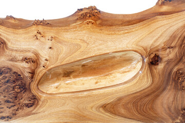 Live edge elm burl slab table top with central epoxy resin river on white background, combining...