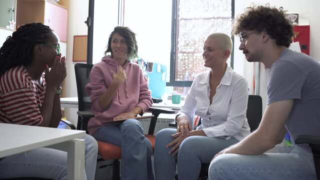In a dynamic college office, a group of students brainstorming about education, culture, human rights, and race equality.	