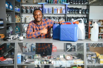 man with canister of motor oil in auto store