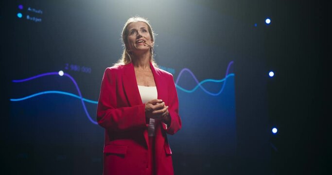 Empowering Female Company CEO Delivering a Positive Earnings Report at a Shareholders Event. Public Speaker Sharing Statistics, Future Goals and Leadership Insights to the Guests in the Room