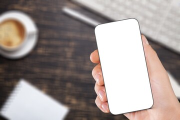 hand holding mobile phone with blank screen