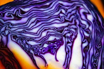 Obraz premium Chopped red cabbage close-up on a cutting wooden board in the kitchen