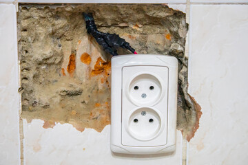 Old electrical outlet on a white wall