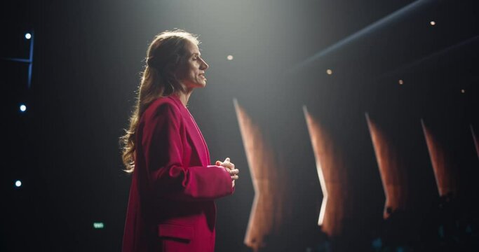 Empowering Female Company CEO Delivering a Positive Earnings Report at a Shareholders Event. Public Speaker Sharing Statistics, Future Goals and Leadership Insights to the Guests in the Room
