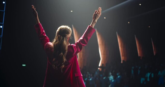 Energetic Female Speaker Giving an Inspiring Talk at a Conference Hall in Front of Motivated Specialists. Presenter Sharing Corporate Success Stories, Winning Business Strategies and Case Studies