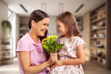 Mother's day concept. Child congratulating mother giving bouquet of flowers.