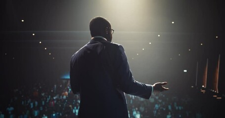 African Businessman Speaking at a Global Economic Strategies at International Business Conference. Public Speaker Sharing Professional Knowledge and Leadership Insights. Footage from Behind