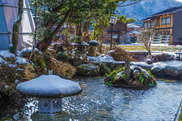 Stone lantern near a pond in Japanese garden