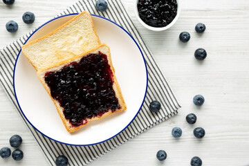 Homemade Blueberry Jam and Toast on a Plate, top view.