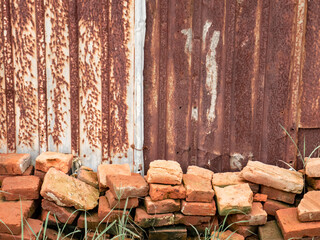 pile of red bricks with a brown background of rusty berries
