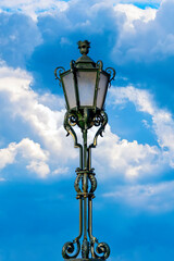Ancient street lamp with sky in the background