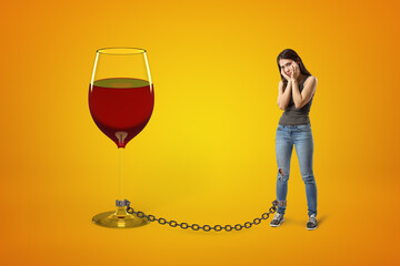 Woman chained to a giant wine glass