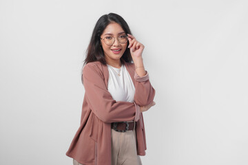 Fototapeta premium Portrait of a young beautiful Asian woman wearing eyeglasses posing like a model, beauty shoot concept.
