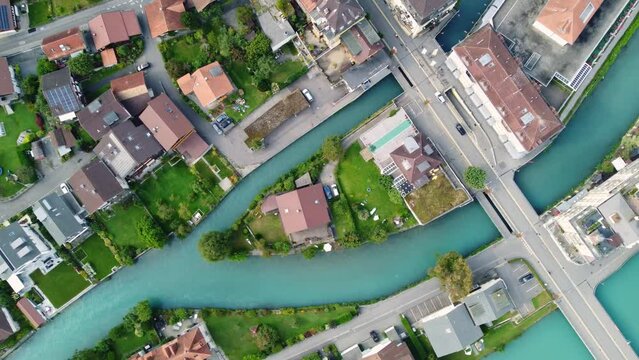 Interlaken, Switzerland: Aerial top down drone footage of the Interlaken old town with the Aar river in Canton Bern in Switzerland.