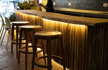 Empty wood table and chairs with interior coffee shop restaurant or cafe