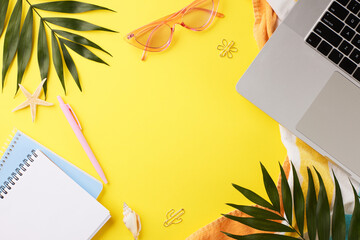 A creative flat lay featuring a laptop and beach accessories on a yellow backdrop, ideal for articles on remote working and digital nomad lifestyles